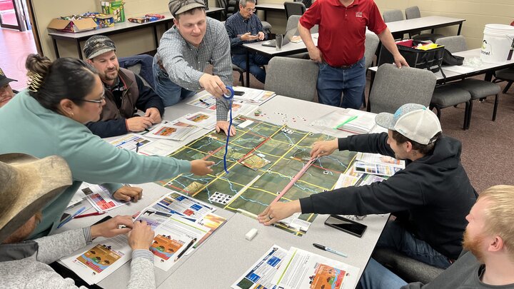Participants learning by playing the "manure game" at a training.