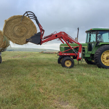 Tractor loading bales