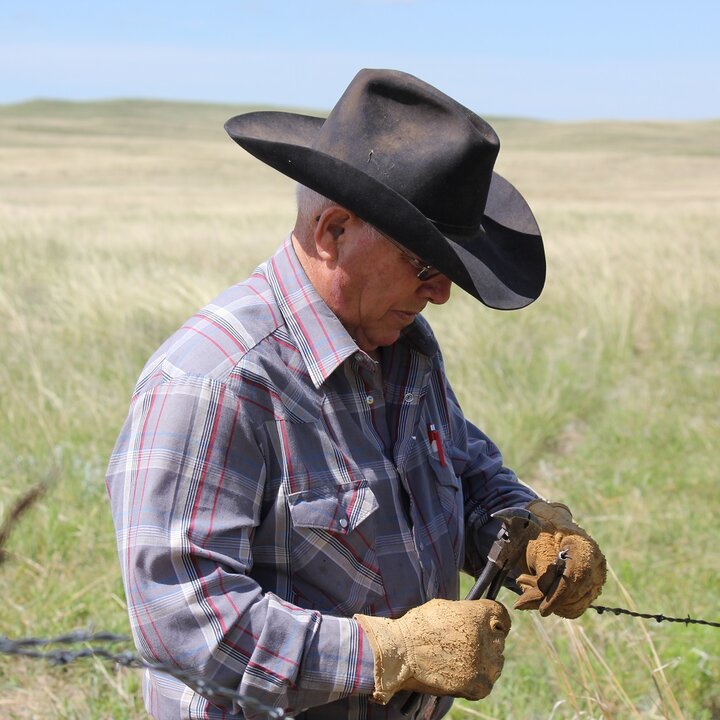 farmer repairing fence