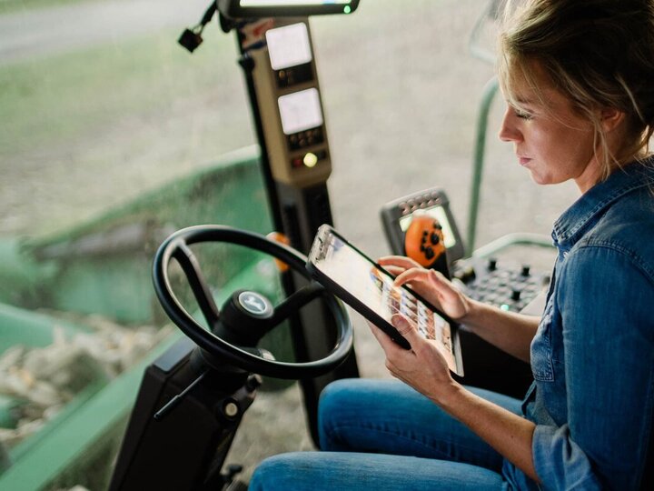 a women in the cab of a combine