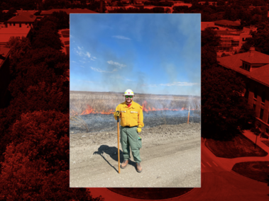 Jacob VanDress stands with a shovel in front of a fire